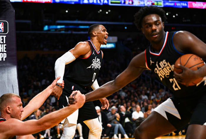 Nov 1, 2023; Los Angeles, California, USA; LA Clippers guard Russell Westbrook (0) and guard Kobe Brown (21) help up teammate center Mason Plumlee (44) against the Los Angeles Lakers during the second quarter at Crypto.com Arena.